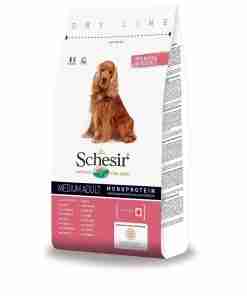 Packaging for Schesir Nature dog food (medium adult, monoprotein) featuring a golden retriever on the front of a white bag.